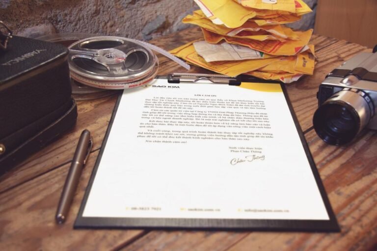 Freelance contract being signed with a pen on a desk